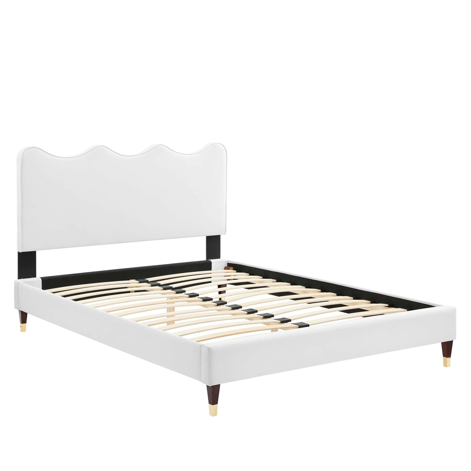 White upholstered full platform bed with scalloped headboard, black rails, wooden slats, and tapered legs with brass tips.
