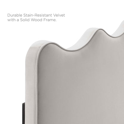 Light gray velvet headboard with scalloped curved top and solid wood frame.