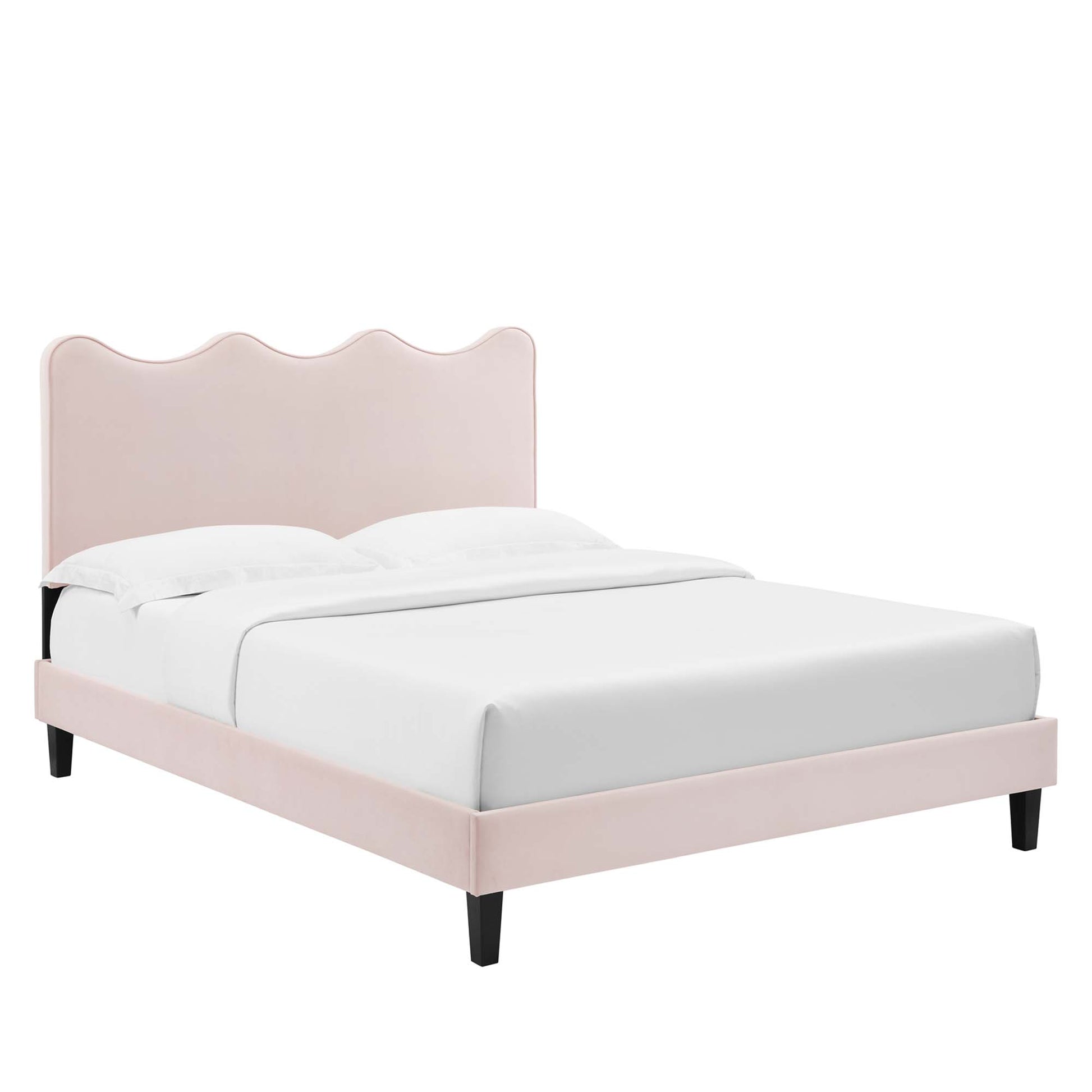 Pink upholstered bed with scalloped, wavy headboard, fabric frame, black tapered legs, white bedding.