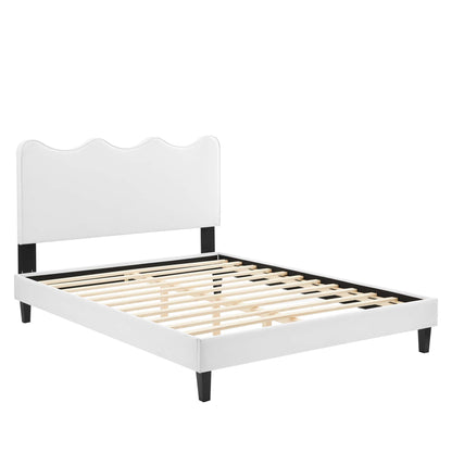 White velvet full platform bed with scalloped headboard, black supports, wooden slats, low-profile modern design.