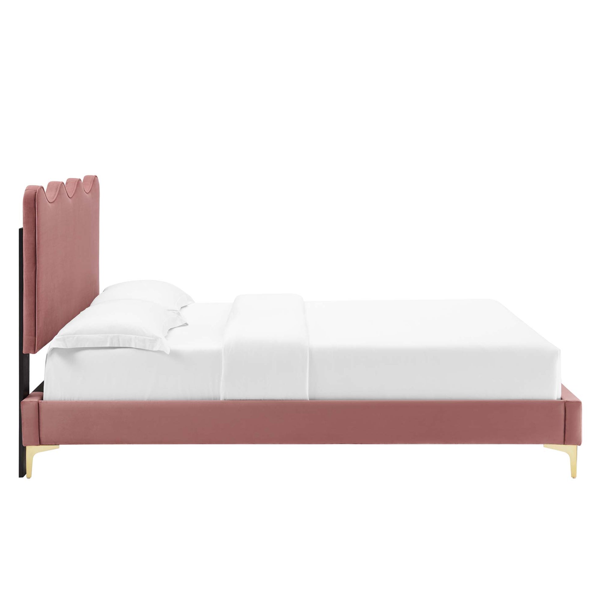Red upholstered platform bed with tall scalloped headboard, low frame and brass legs, white bedding.