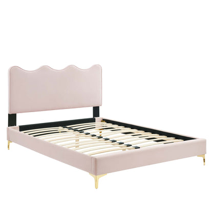 Red velvet upholstered queen platform bed with a scalloped wavy headboard, black supports and gold feet; slatted platform.