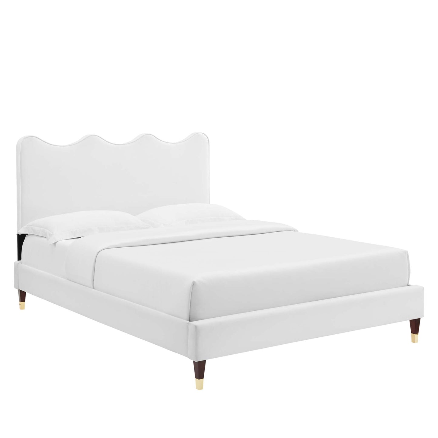 White upholstered queen platform bed with curved scalloped headboard, clean lines, wooden legs with gold caps, white bedding.