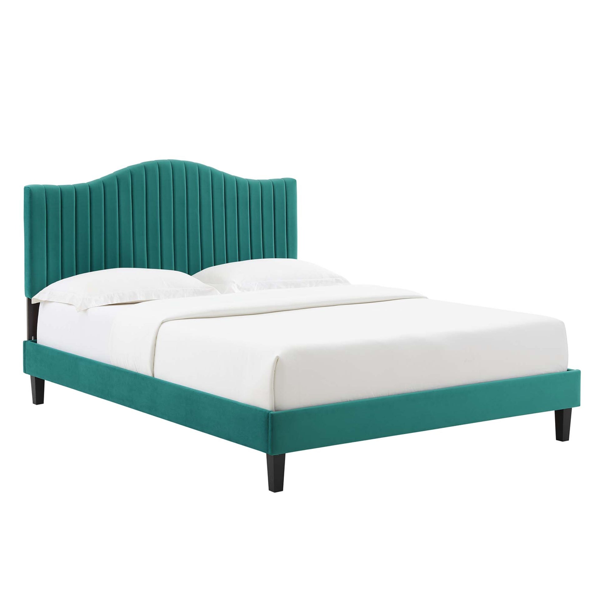 Teal velvet bed with curved, vertical channel-tufted headboard and low platform frame; black legs, white bedding.
