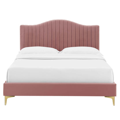 Pink velvet bed with vertical channel-tufted curved headboard, low footboard and gold legs, white bedding.