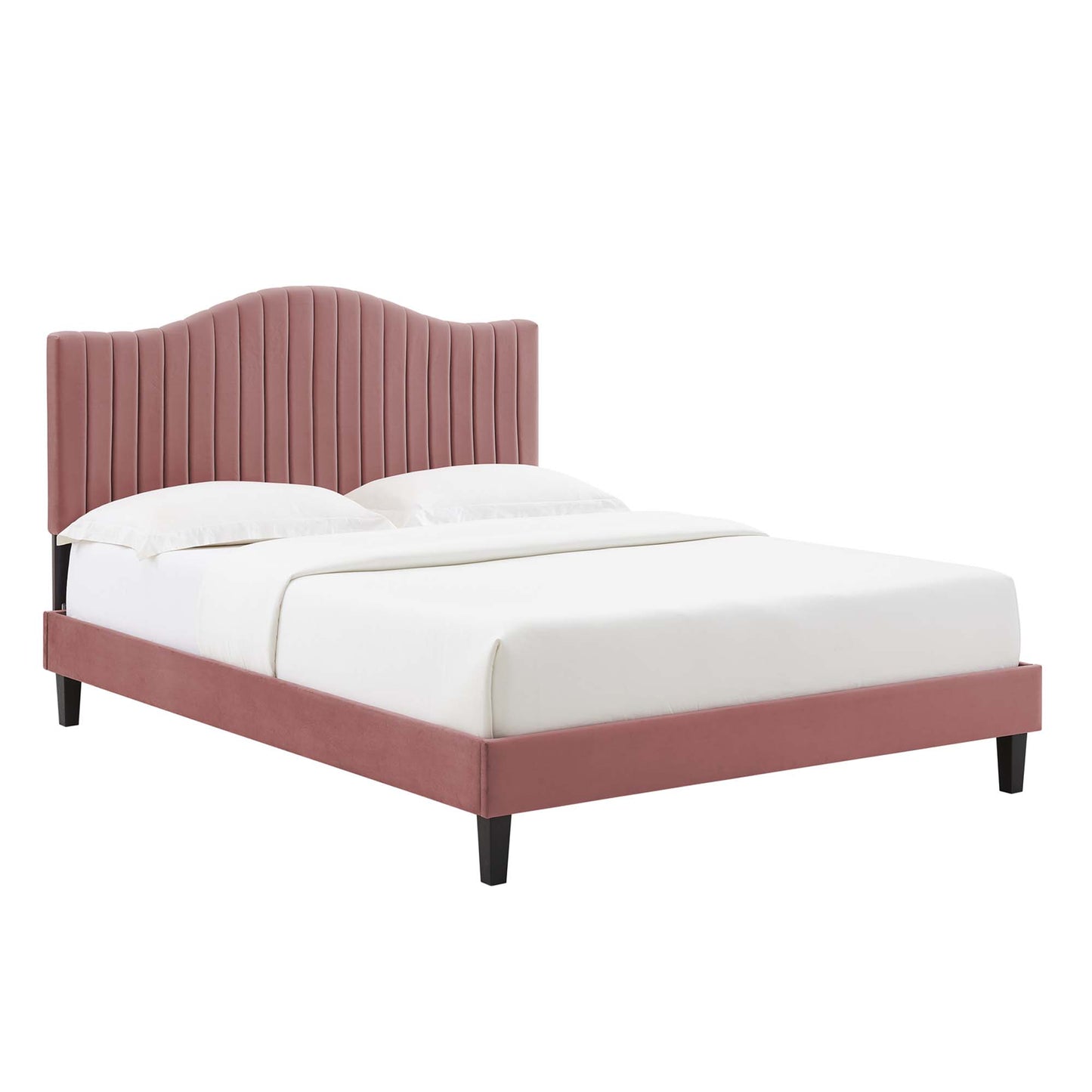 Pink velvet platform bed with a curved, channel-tufted headboard, pink frame, black tapered legs, and white bedding.