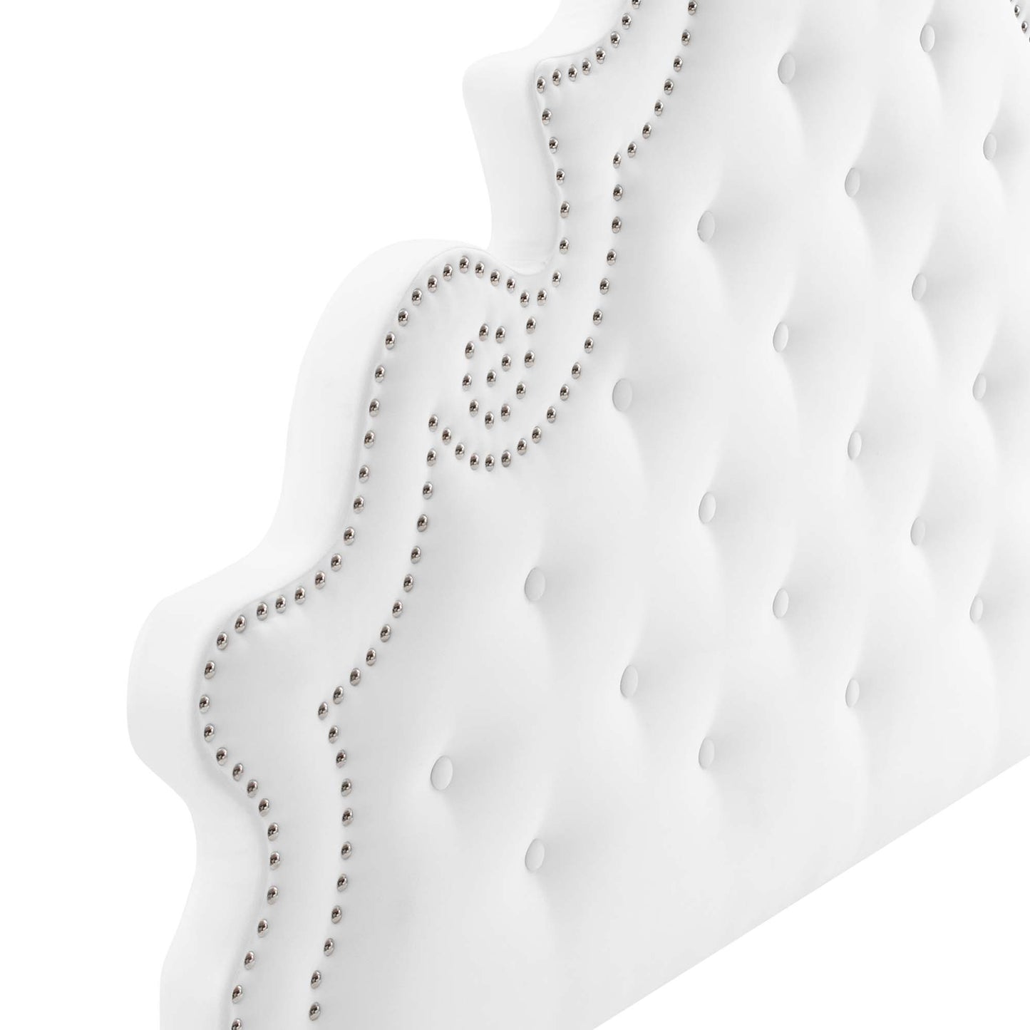 White tufted velvet queen platform bed with a curved scalloped headboard and silver nailhead trim.