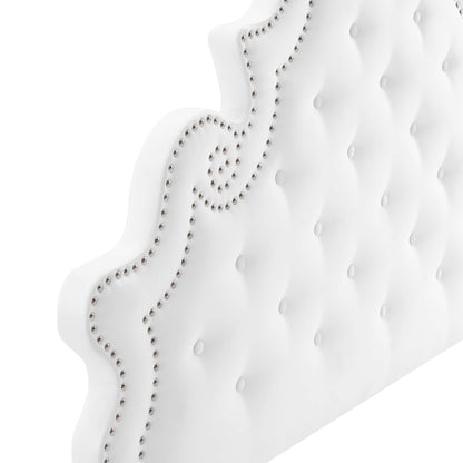 White tufted velvet queen platform bed with a curved scalloped headboard and silver nailhead trim.
