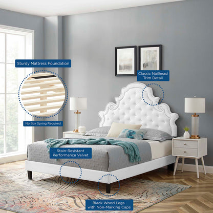 White tufted velvet twin platform bed with nailhead trim and black wood legs in a modern gray bedroom.