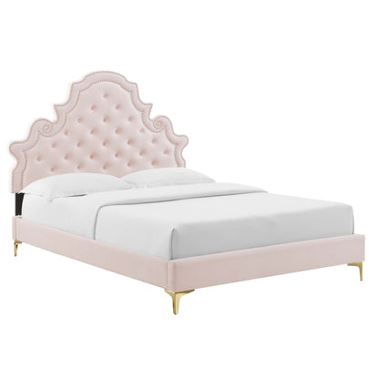 Red tufted curved headboard bed with matching upholstered frame, white bedding, and gold legs.