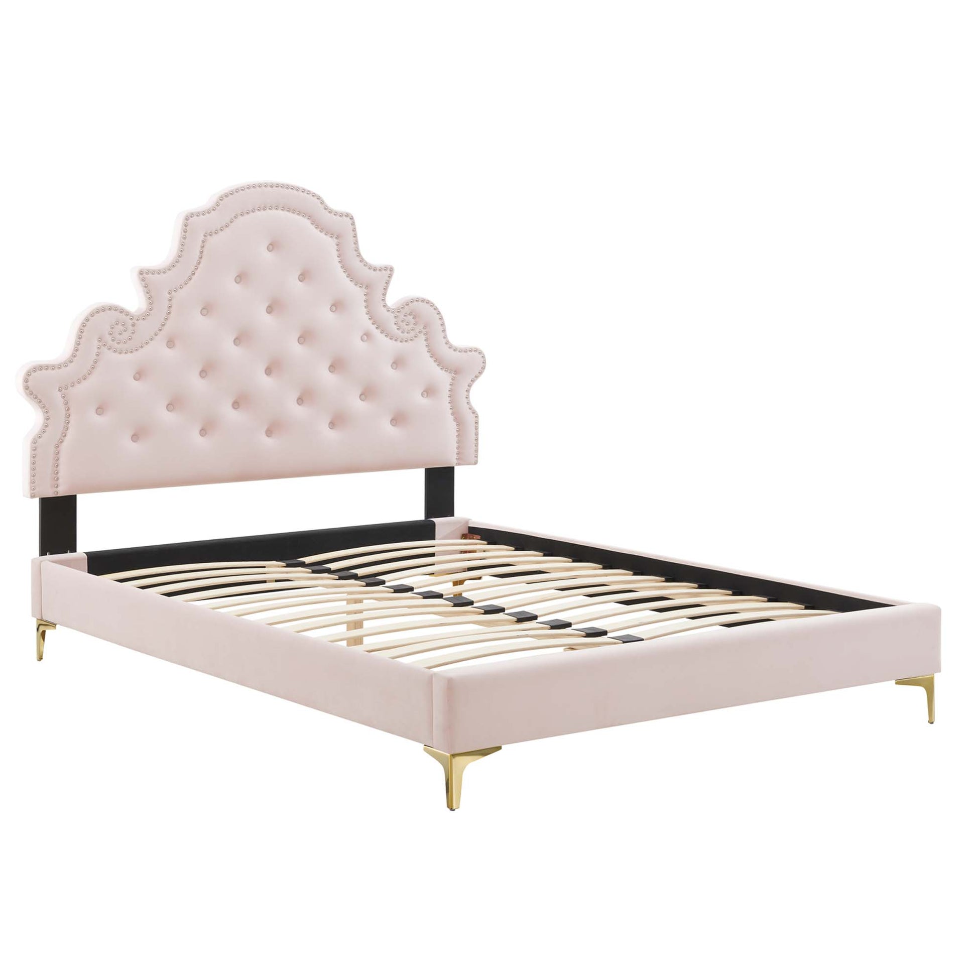 Blush pink upholstered platform bed with tufted scalloped headboard, black rails, gold legs, and wooden slat base.