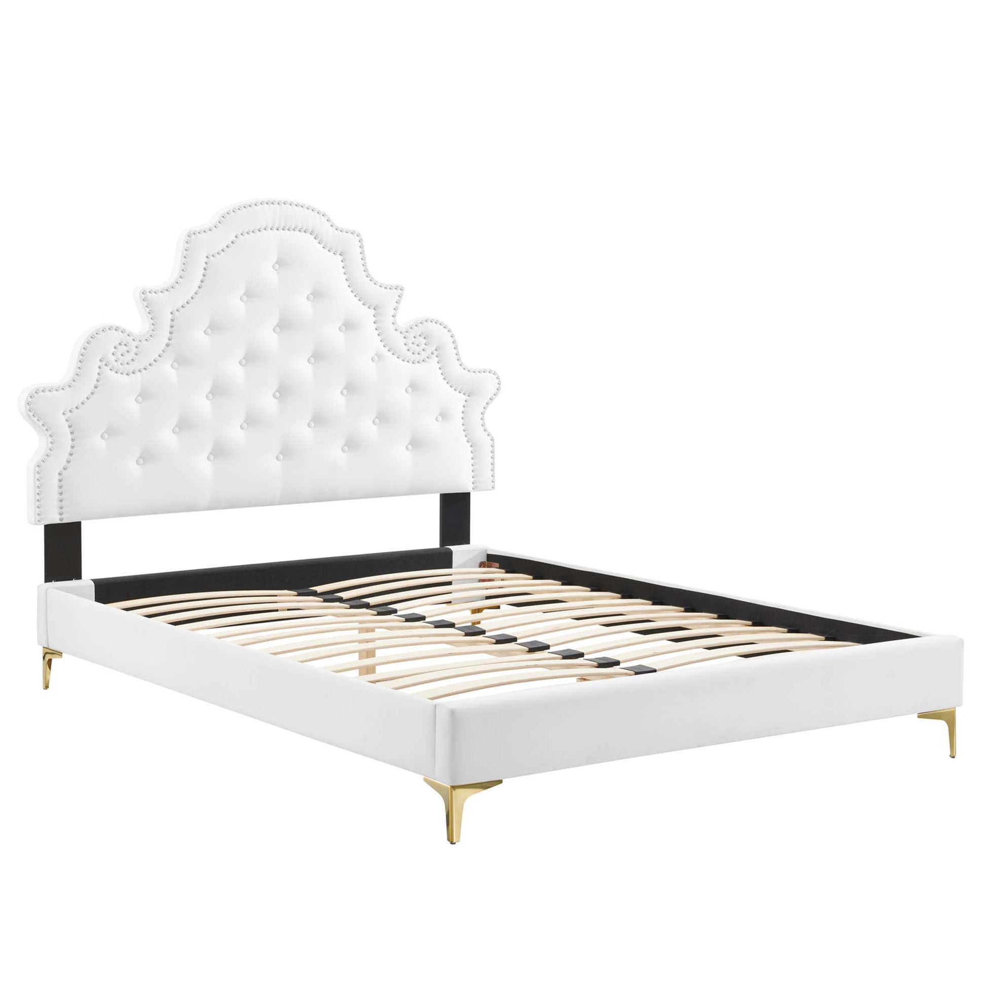 White tufted upholstered full platform bed with a scalloped headboard.
