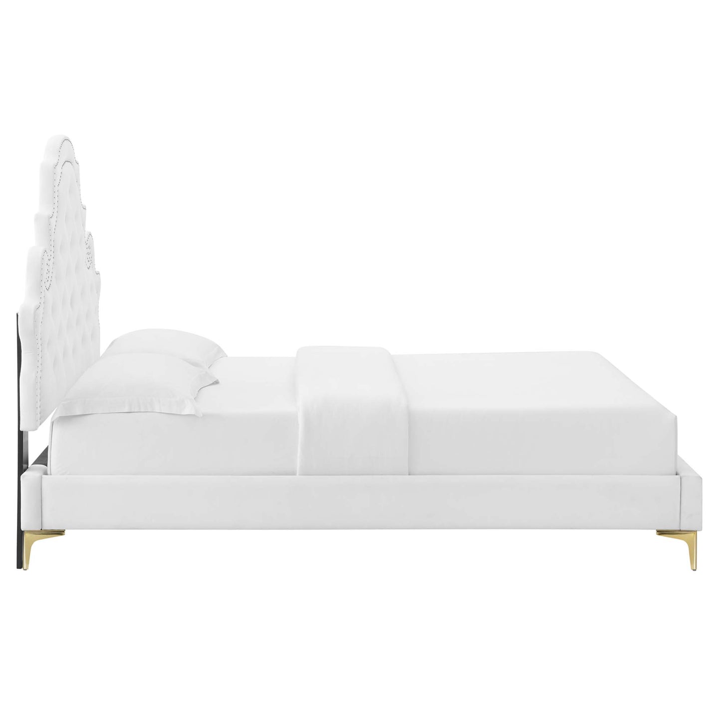 White velvet tufted full platform bed with a tall headboard, low platform frame, dressed in white linens.