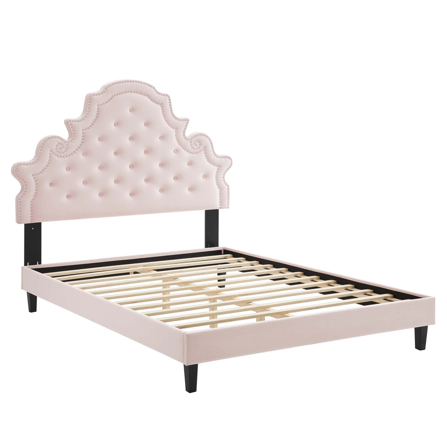 Pink tufted velvet full platform bed with ornate scalloped headboard, black posts, pale pink rails, and wooden slats.