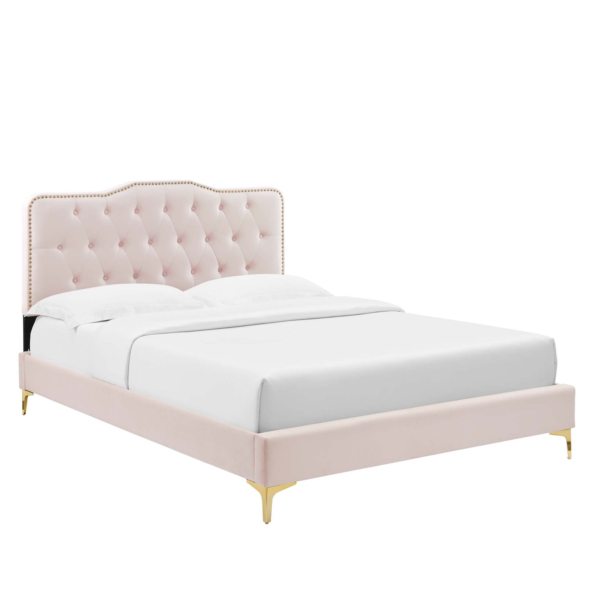 Pink velvet tufted bed with curved headboard, nailhead trim, gold legs, white bedding.