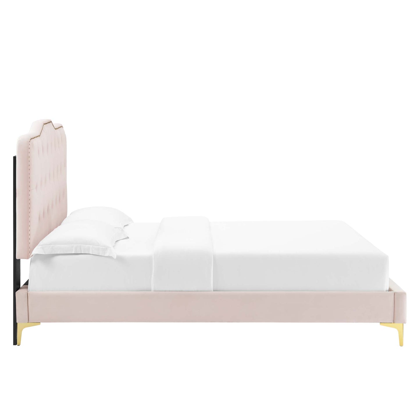 Blush pink upholstered platform bed with tufted tall headboard and gold-tipped legs, dressed in white bedding.