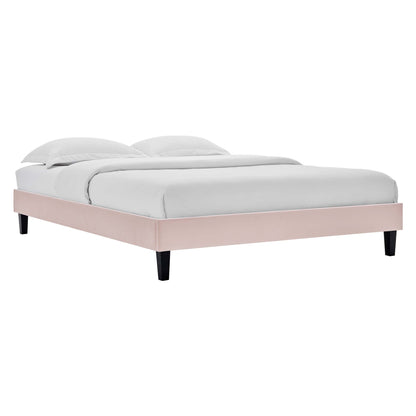 Pink platform bed frame with light gray bedding and two pillows; modern low-profile design, black tapered legs.
