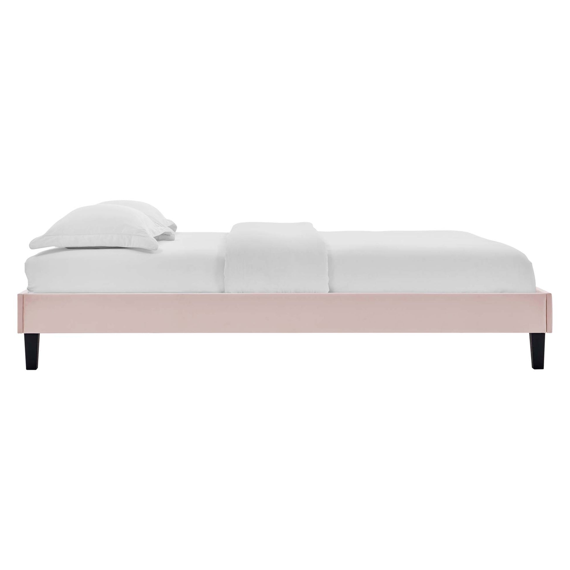 Pink wooden platform bed with white bedding, low profile frame and black tapered legs; modern minimalist bedroom.