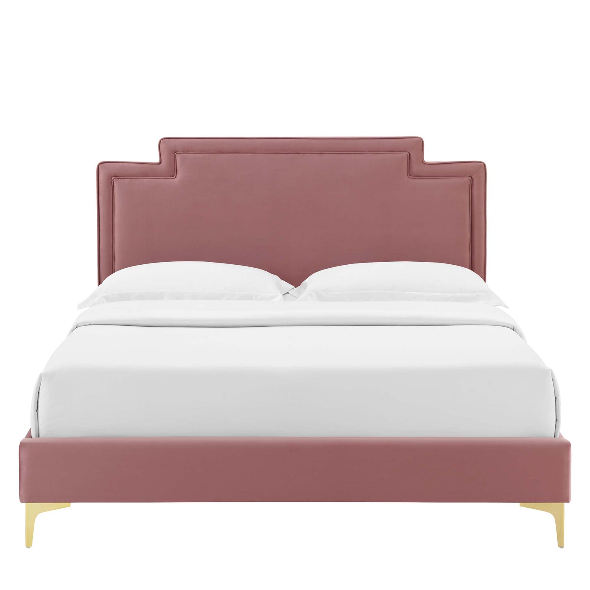 Dusty-rose velvet upholstered bed with stepped panel headboard, low footboard, & gold legs, dressed in white bedding.