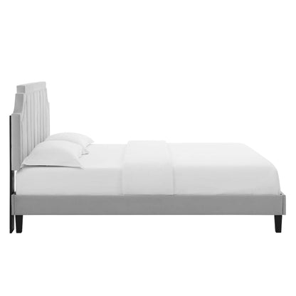 Light gray upholstered platform bed with a tall paneled headboard and white bedding.