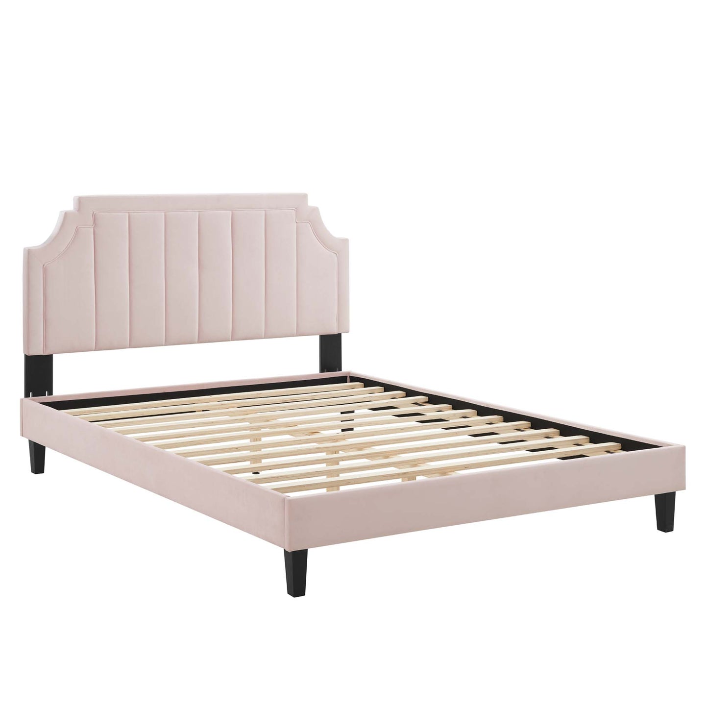 Blush pink upholstered bed frame with tufted vertical panels, curved corner headboard, black legs, and wooden slat base.