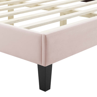 Pink upholstered bed frame with slatted wooden base & black tapered leg.