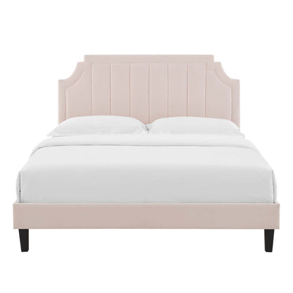 Blush pink upholstered bed with tall paneled headboard and black tapered legs, white bedding.