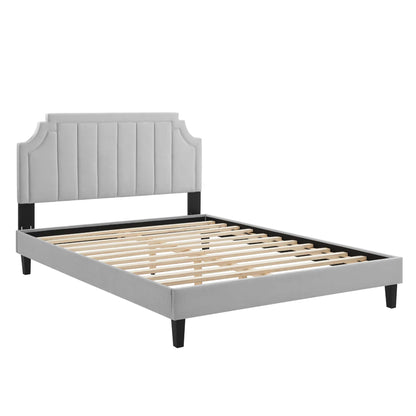 Light gray upholstered full platform bed with vertical-tufted headboard, dark legs, and slatted base.