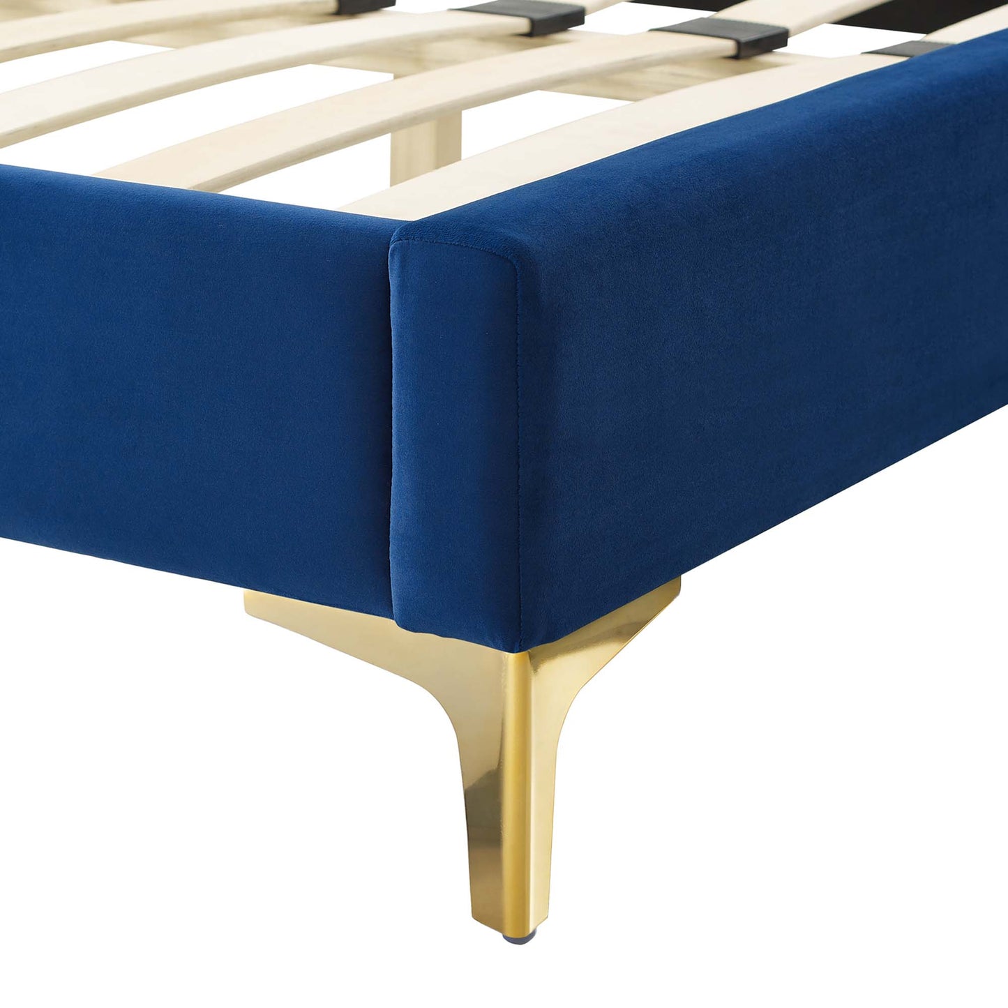 Navy blue upholstered bed frame corner with gold-finished metal leg and wooden slat support.