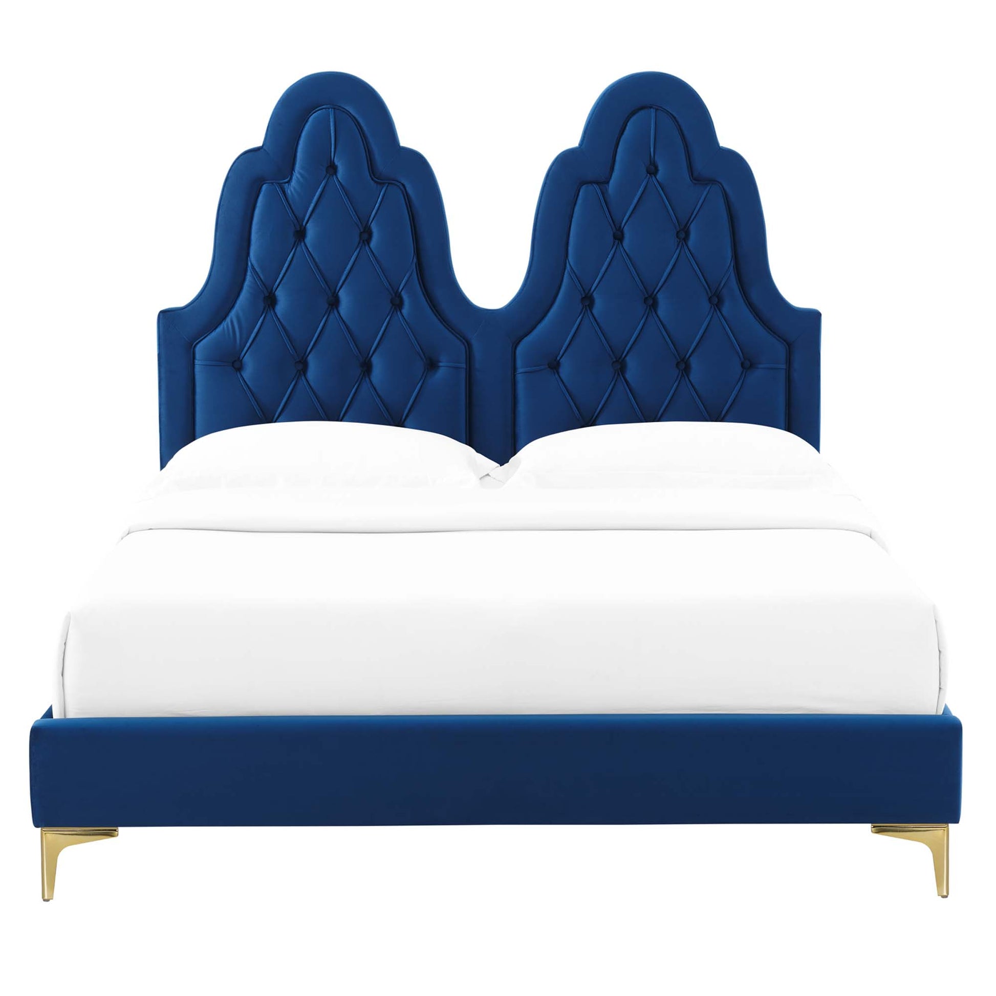 Navy velvet upholstered twin platform bed with a double-arched tufted headboard, gold legs, & white bedding.