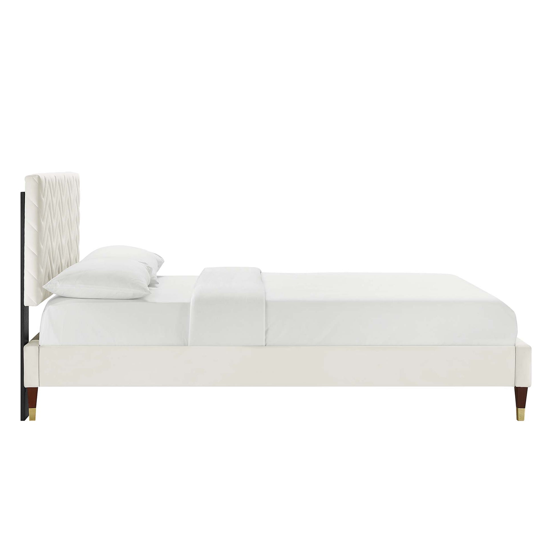 White upholstered platform bed with tall quilted headboard, cream fabric, slim gold-tipped legs, modern style.