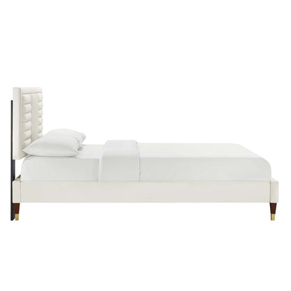 White upholstered bed with tall tufted headboard, platform frame, modern bedroom furniture.