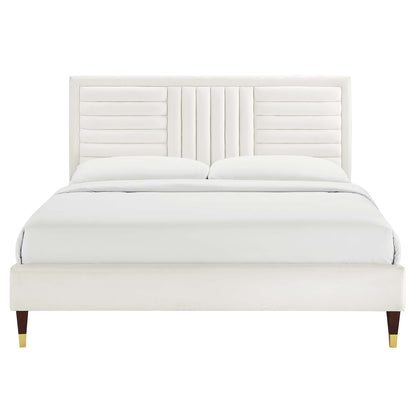 White velvet channel-tufted queen platform bed.