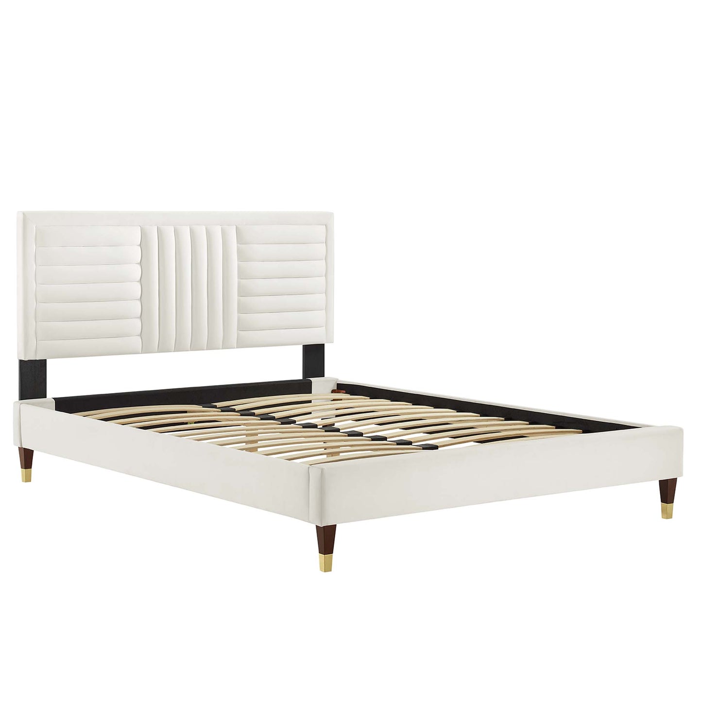 White upholstered platform bed with padded headboard, black rails, and wooden slats; tapered wood legs with brass tips.