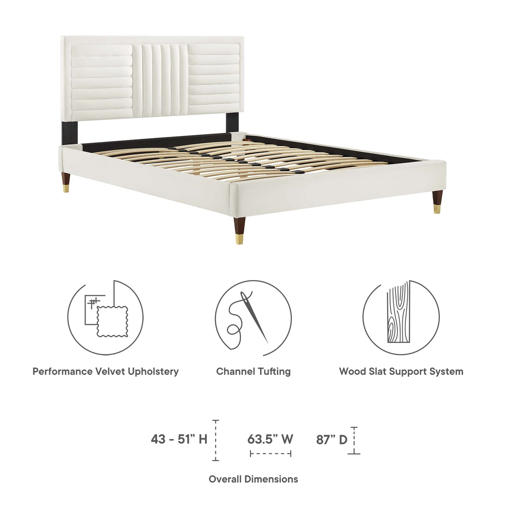 White upholstered platform bed with channel-tufted headboard, black tapered legs with gold tips, wooden slat support system.