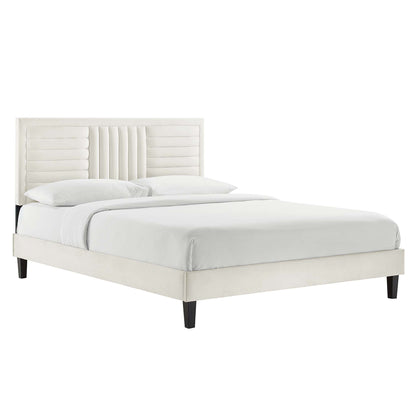 White upholstered platform bed with a paneled, channel-tufted headboard and dark wooden legs.
