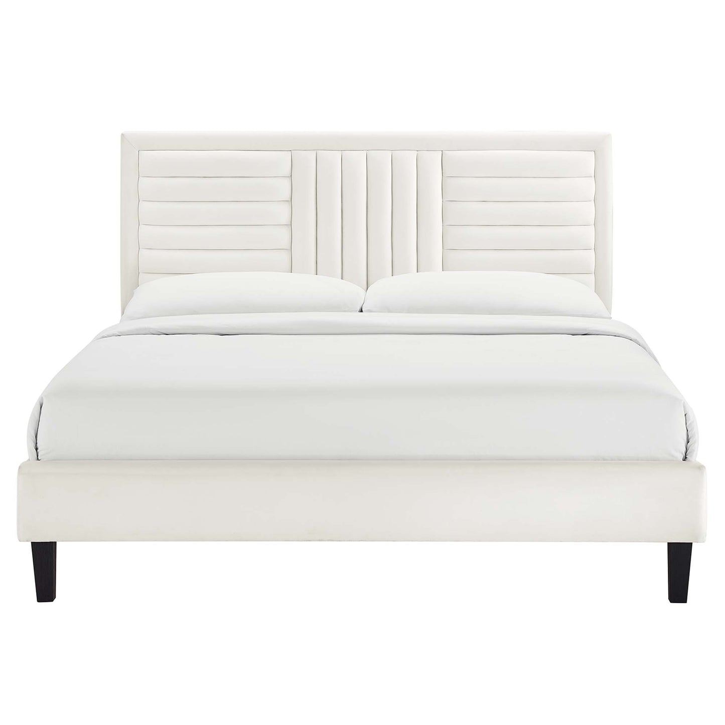 Cream upholstered platform bed with vertical-channel headboard and black tapered legs, dressed in white bedding.