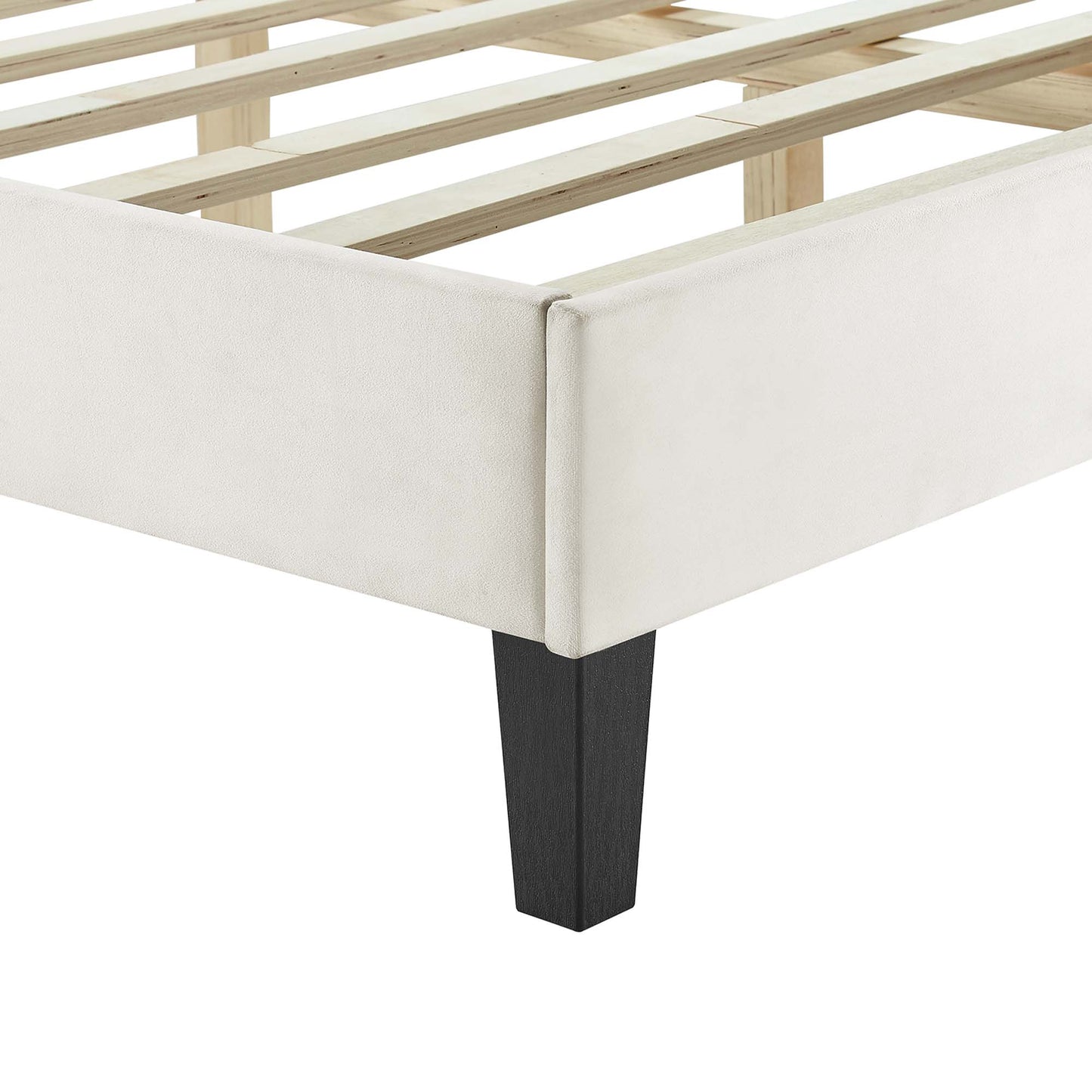 White upholstered queen platform bed frame with natural wood slats and black tapered legs.