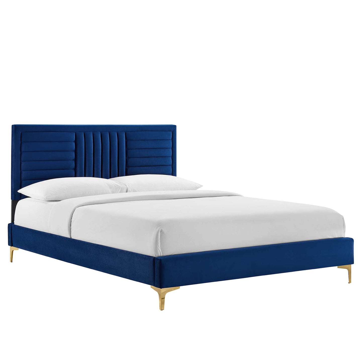 Navy velvet bed with tall, vertically paneled tufted headboard, gold legs, and white bedding for a modern luxe look.