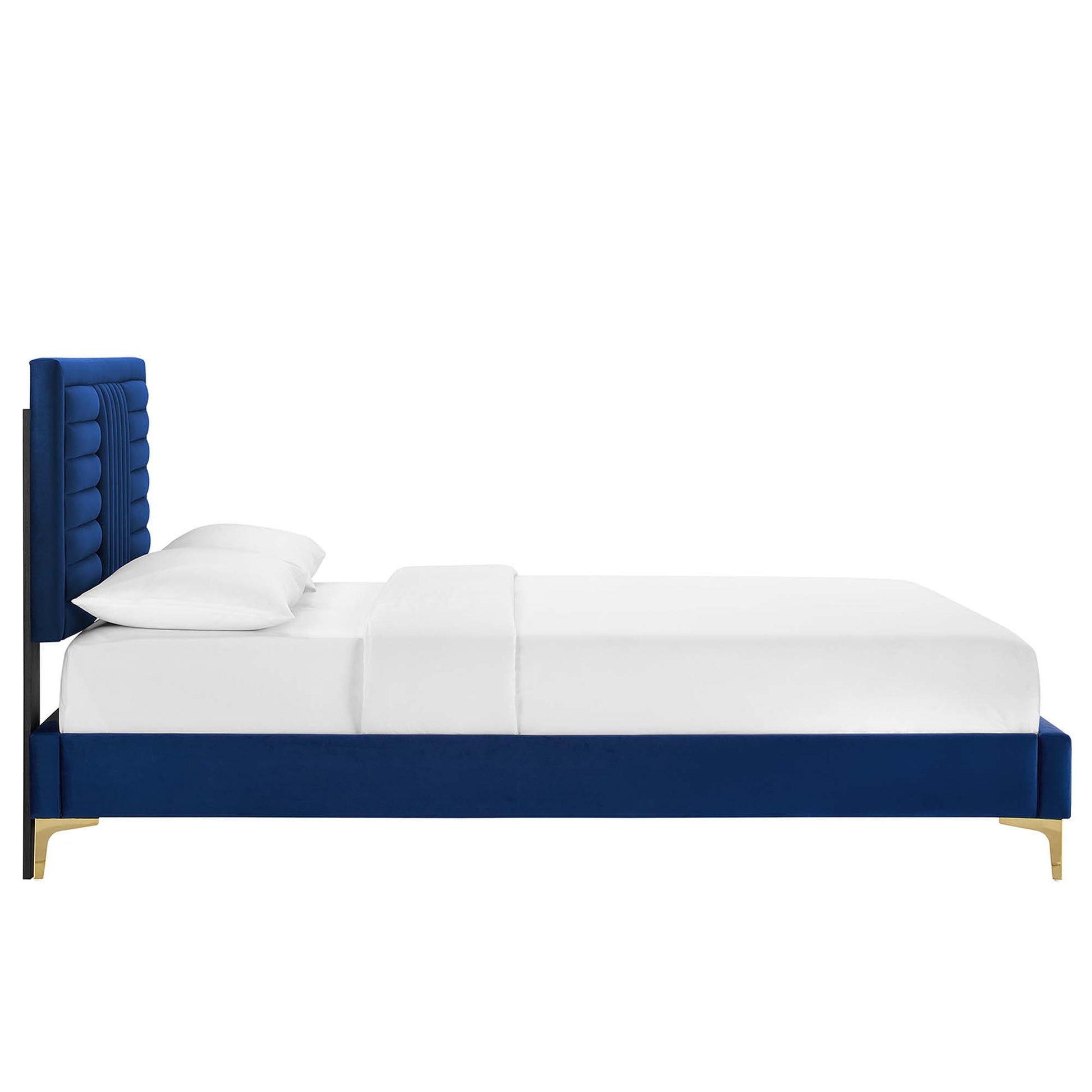 Navy blue velvet platform bed with tall tufted headboard, gold legs and white bedding.