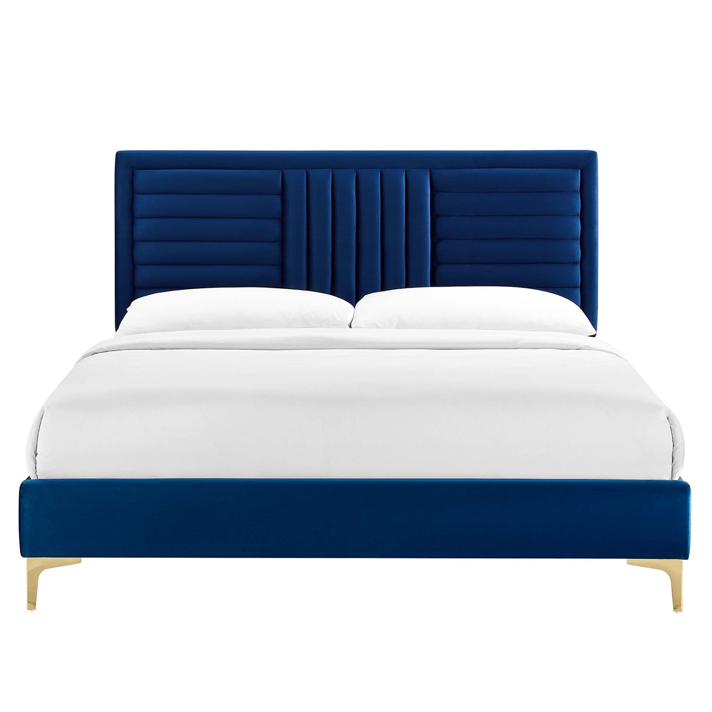 Navy velvet upholstered bed with vertical channel-tufted headboard, low footboard, and gold legs, dressed in white bedding.