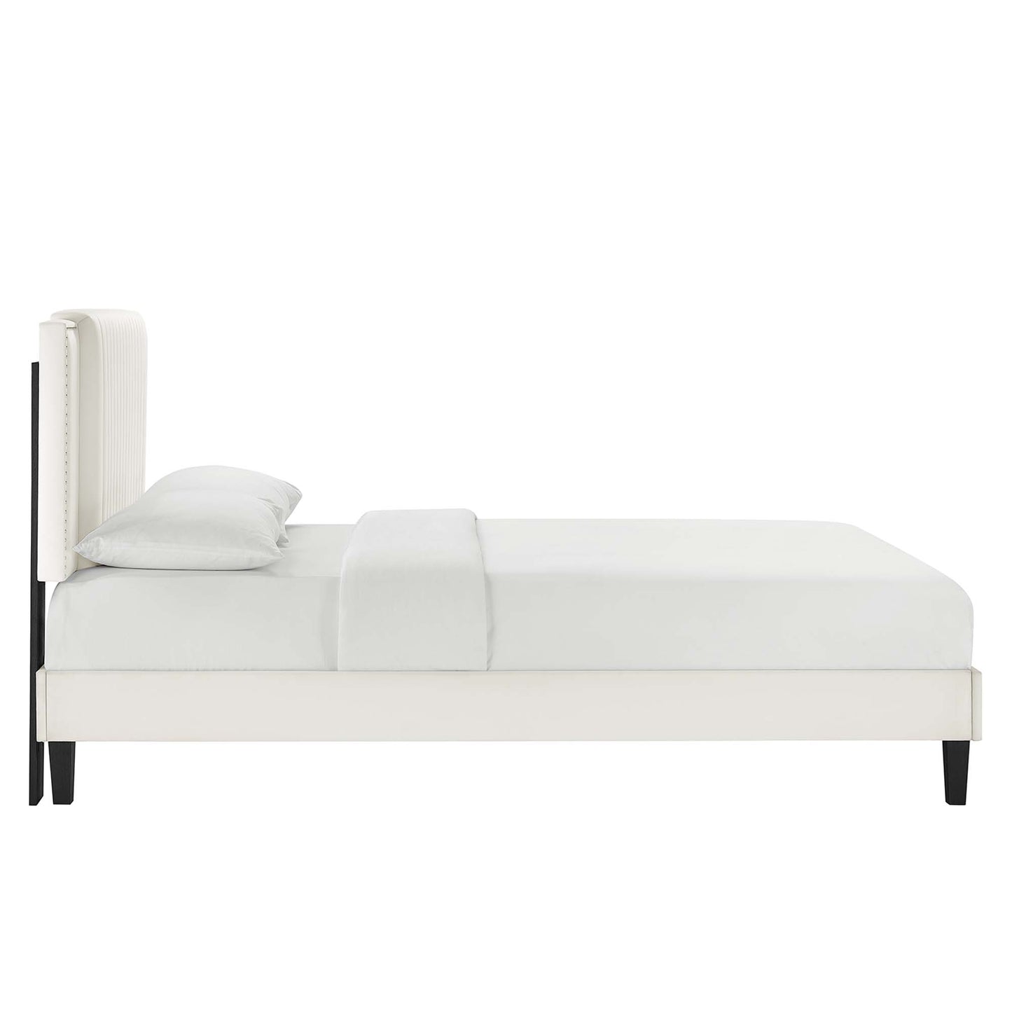 White upholstered platform bed with tall padded headboard, light bedding, and black tapered legs; modern minimalist style.