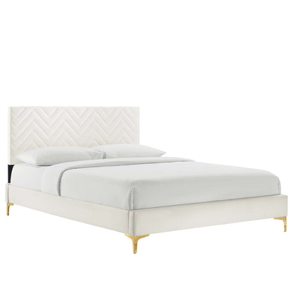 White upholstered bed with chevron-tufted headboard, cream frame and gold-finish legs.