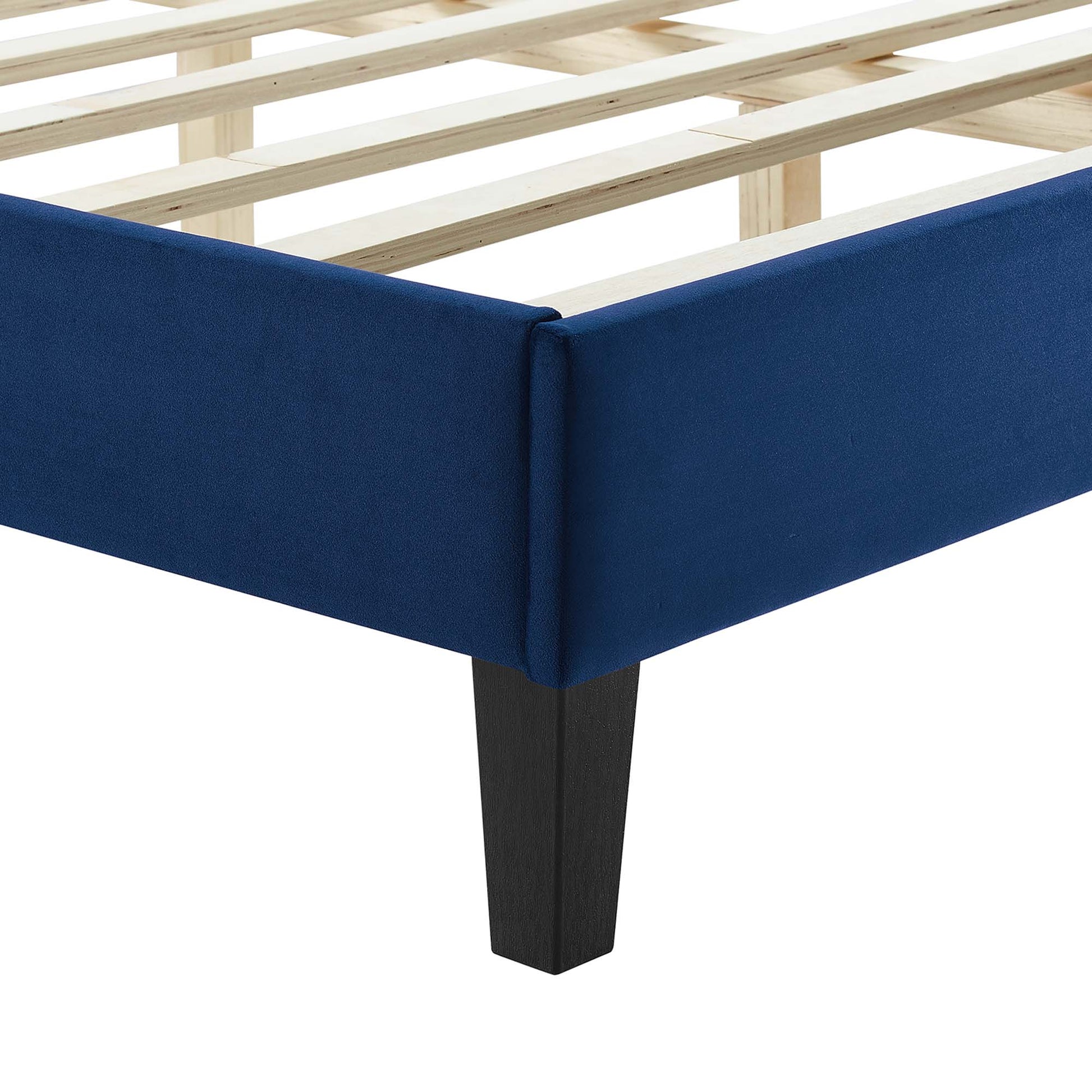 Navy blue upholstered full platform bed with dark tapered legs.