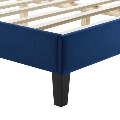 Navy blue upholstered full platform bed with dark tapered legs.