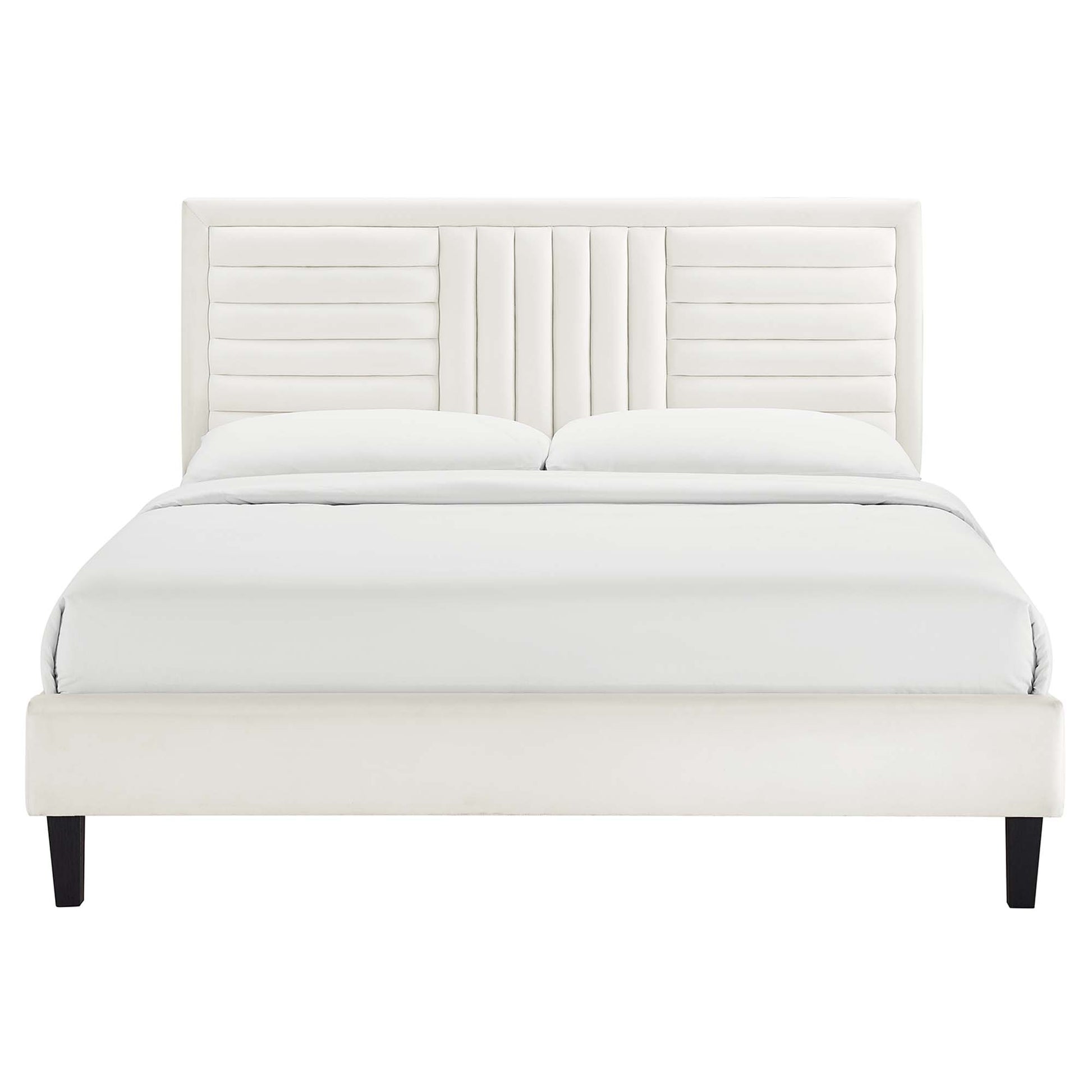 White upholstered platform bed with a paneled, channel-tufted headboard and dark tapered legs.
