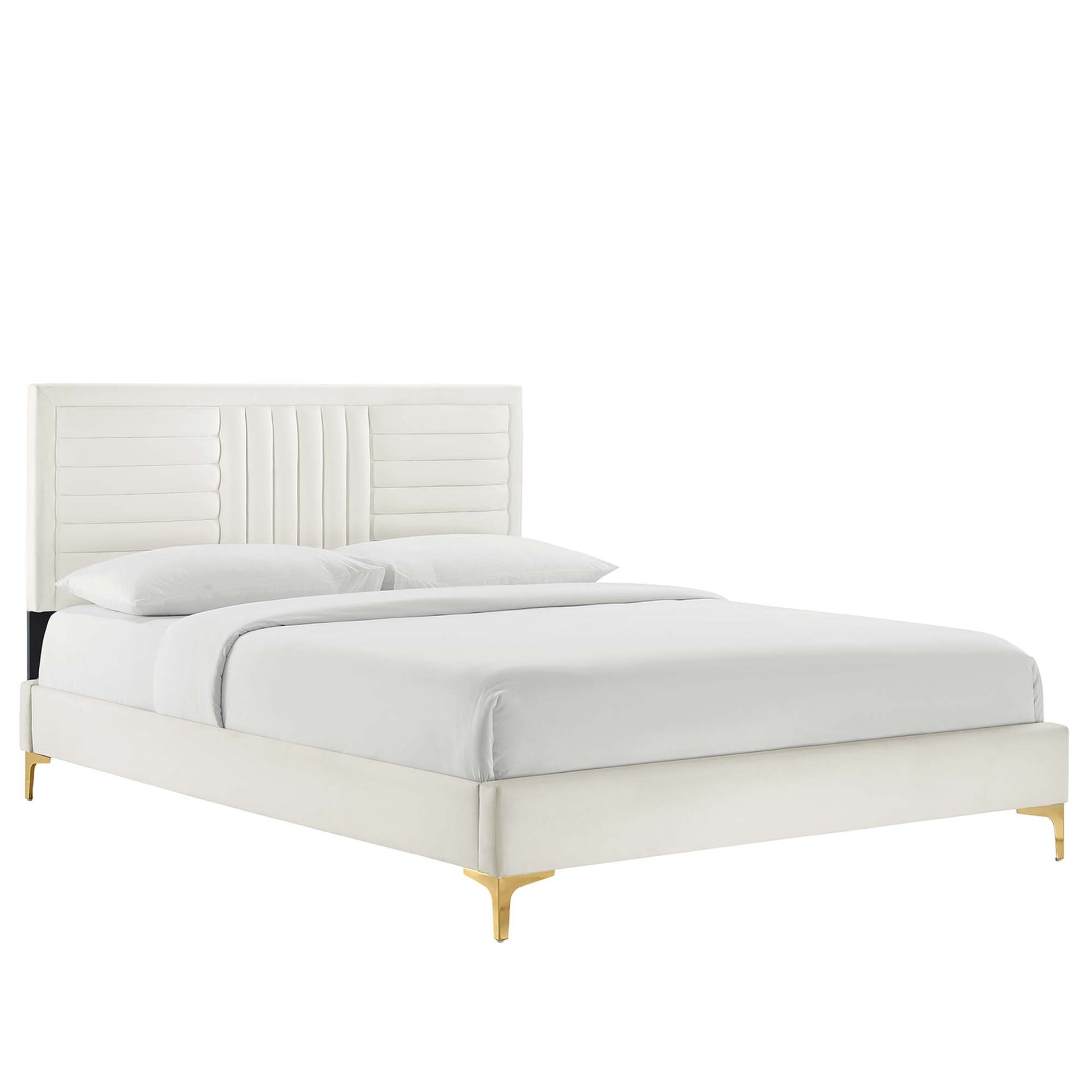 Ivory upholstered platform bed with tall paneled headboard & vertical channel tufting, low frame & gold legs, white bedding.