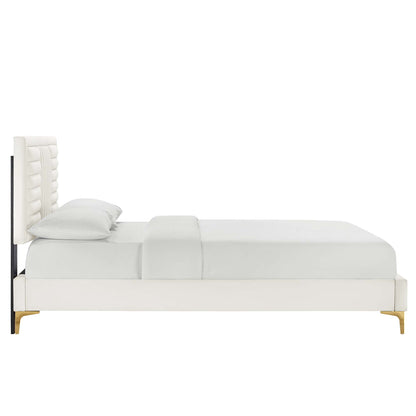 White upholstered platform bed with tall tufted headboard and white bedding, paired with light wood legs.