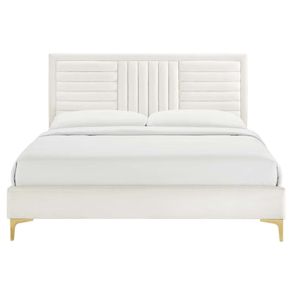 White channel-tufted velvet platform bed with white bedding.
