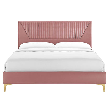 Dusty rose velvet upholstered bed with tall, channel-tufted headboard, low footboard and gold metal legs, white bedding.